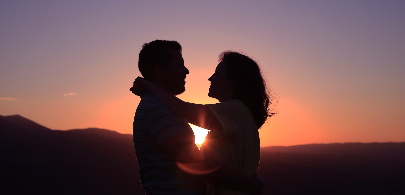 silhouette of hugging couple